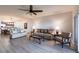 Spacious living room with updated flooring, ceiling fan, and open to dining room and kitchen at 93 Vivante Blvd # 9323, Punta Gorda, FL 33950