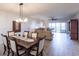Living and dining area featuring hardwood flooring and access to a private balcony overlooking the water at 93 Vivante Blvd # 9323, Punta Gorda, FL 33950