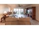 Spacious living room with updated flooring, ceiling fan, and sliding glass doors to deck at 93 Vivante Blvd # 9323, Punta Gorda, FL 33950