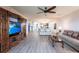 Bright living room featuring hardwood floors, large television, and a ceiling fan above cozy sofas at 93 Vivante Blvd # 9323, Punta Gorda, FL 33950