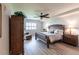Spacious main bedroom featuring hardwood floors, a ceiling fan, a wooden bed frame, and a sitting area at 93 Vivante Blvd # 9323, Punta Gorda, FL 33950