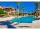 Resort style community pool with lush tropical landscaping and lounge chairs on a bright sunny day at 93 Vivante Blvd # 9323, Punta Gorda, FL 33950