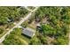Aerial view showcasing the home's location amidst lush greenery and a neighboring street at 11401 2Nd Ave, Punta Gorda, FL 33955