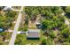 Aerial view showcasing the home's location amidst lush greenery and a neighboring street at 11401 2Nd Ave, Punta Gorda, FL 33955