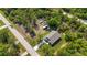 Aerial view showcasing the home's location amidst lush greenery and a neighboring street at 11401 2Nd Ave, Punta Gorda, FL 33955