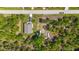 Aerial view showcasing the home's location amidst lush greenery and a neighboring street at 11401 2Nd Ave, Punta Gorda, FL 33955