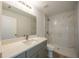 Bathroom featuring marble tiled shower, gray vanity with white countertop and modern faucet at 11401 2Nd Ave, Punta Gorda, FL 33955