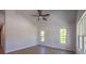 Bright bedroom featuring vaulted ceilings, wood-look flooring, and multiple windows at 11401 2Nd Ave, Punta Gorda, FL 33955