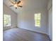 A bedroom with hardwood floors, closet, ceiling fan and two windows at 11401 2Nd Ave, Punta Gorda, FL 33955
