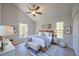 Bright and airy bedroom featuring a wooden bed frame, neutral bedding, and natural light, creating a serene and relaxing atmosphere at 11401 2Nd Ave, Punta Gorda, FL 33955