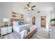 Spacious bedroom featuring a wooden bed frame, neutral bedding, decor, and access to closet at 11401 2Nd Ave, Punta Gorda, FL 33955