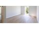 Bright bedroom featuring light wood flooring and door to outside at 11401 2Nd Ave, Punta Gorda, FL 33955