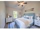 Cozy bedroom featuring a blue upholstered bed, white dressers, and natural light, creating a relaxing and inviting atmosphere at 11401 2Nd Ave, Punta Gorda, FL 33955