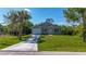 Charming single-story home with well-maintained lawn and attached garage with a palm tree at 11401 2Nd Ave, Punta Gorda, FL 33955