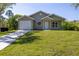 Charming one-story home with a well-manicured front yard and a one car garage at 11401 2Nd Ave, Punta Gorda, FL 33955