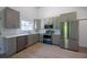 Modern kitchen boasts stainless steel appliances, gray cabinets, and sleek countertops at 11401 2Nd Ave, Punta Gorda, FL 33955