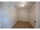 Spacious walk-in closet features wire shelving and light wood floors at 11401 2Nd Ave, Punta Gorda, FL 33955