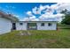 A spacious green backyard features a white storage building with gated access at 1214 Ansin St, Punta Gorda, FL 33950