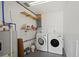 Bright laundry room featuring modern washer and dryer, shelving, and functional utility elements at 1214 Ansin St, Punta Gorda, FL 33950