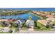 Aerial view of the property showcasing its desirable location on a lake with lush surroundings at 13056 N Marsh Dr, Port Charlotte, FL 33953