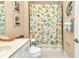 Bathroom with white vanity, coastal shower curtain, and decorative seashell accents at 13056 N Marsh Dr, Port Charlotte, FL 33953