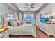 Comfortable bedroom with wooden floors features a ceiling fan, queen bed, and plenty of natural light at 13056 N Marsh Dr, Port Charlotte, FL 33953