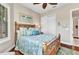 Comfortable bedroom with a wooden bed frame, closet, and beachy-themed decor at 13056 N Marsh Dr, Port Charlotte, FL 33953