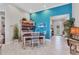 Inviting dining room with blue accent wall and a view towards the home's beautifully decorated entryway at 13056 N Marsh Dr, Port Charlotte, FL 33953