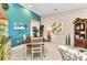Dining room featuring bright blue accent wall with coordinating artwork and a traditional dining set at 13056 N Marsh Dr, Port Charlotte, FL 33953
