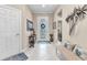 Inviting entryway with tile floors, decorative accents, and transom window above the front door at 13056 N Marsh Dr, Port Charlotte, FL 33953