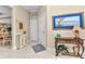 Inviting entryway featuring coastal decor, tile flooring, and a serene color palette at 13056 N Marsh Dr, Port Charlotte, FL 33953