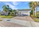 Charming single-story home with a white garage door and meticulously maintained landscaping at 13056 N Marsh Dr, Port Charlotte, FL 33953