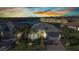 Beautiful single-Gathering home with lush landscaping and a gorgeous lake view at sunset at 13056 N Marsh Dr, Port Charlotte, FL 33953