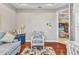 Cozy office space with wood floors, blue accents, and views into other rooms at 13056 N Marsh Dr, Port Charlotte, FL 33953