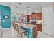 Stylish kitchen featuring a large granite island with seating, pendant lighting, and modern appliances at 13056 N Marsh Dr, Port Charlotte, FL 33953