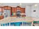 Bright kitchen featuring granite countertops, wood cabinets, and a large island with seating at 13056 N Marsh Dr, Port Charlotte, FL 33953