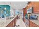 Open kitchen featuring granite countertops, stainless appliances, and views of the breakfast nook at 13056 N Marsh Dr, Port Charlotte, FL 33953