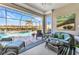 Comfortable lanai space leading to the screened pool area with views of lush landscaping and the community at 13056 N Marsh Dr, Port Charlotte, FL 33953