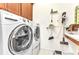 Functional laundry room with front-load washer/dryer and upper cabinets for storage at 13056 N Marsh Dr, Port Charlotte, FL 33953
