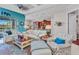 Inviting living room with comfortable seating, a view to the open concept kitchen and lots of natural light at 13056 N Marsh Dr, Port Charlotte, FL 33953