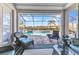 Inviting patio with comfortable seating overlooking a sparkling pool and tranquil waterfront at 13056 N Marsh Dr, Port Charlotte, FL 33953