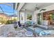 Screened patio with comfortable seating, a ceiling fan, and access to the backyard at 13056 N Marsh Dr, Port Charlotte, FL 33953