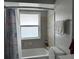 Bathroom showcasing a tiled shower and tub combination and a window providing natural light at 137 Revere Nw St, Port Charlotte, FL 33952