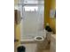 Small yellow bathroom with white tile shower at 137 Revere Nw St, Port Charlotte, FL 33952