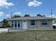 Charming home with neutral exterior paint, white trim, a well-maintained lawn, and manicured landscaping at 137 Revere Nw St, Port Charlotte, FL 33952