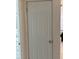 Hallway showing a door, the adjacent bathroom and neutral wall colors at 137 Revere Nw St, Port Charlotte, FL 33952