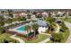 Aerial view of the community pool, lined with lounge chairs and surrounded by palm trees at 14049 Black Beauty Dr # 721, Punta Gorda, FL 33955