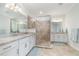 Modern bathroom with dual sinks, granite countertops, and a glass-enclosed shower with tile surround at 14049 Black Beauty Dr # 721, Punta Gorda, FL 33955