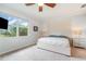 Bright bedroom with a large window, a ceiling fan, and neutral decor for a serene atmosphere at 14049 Black Beauty Dr # 721, Punta Gorda, FL 33955