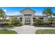 Exterior view of a modern clubhouse showcasing its architectural design and well-manicured landscaping at 14049 Black Beauty Dr # 721, Punta Gorda, FL 33955